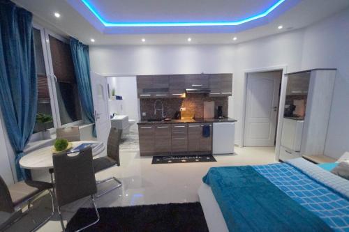 a bedroom with a bed and a kitchen with a table at Pension / Zimmervermietung Wasbek in Wasbek