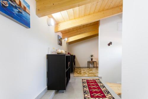 a living room with a black cabinet and wooden ceilings at Villa Del Mar in Vasiliki