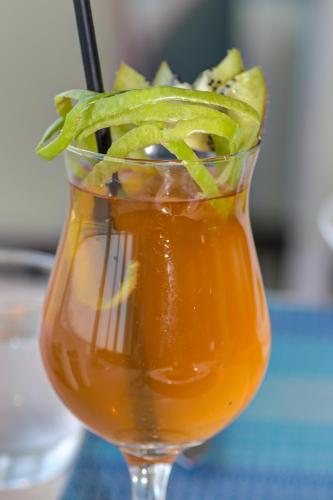a vase filled with a drink with green peppers at Lancaster Eden Bay in Beirut
