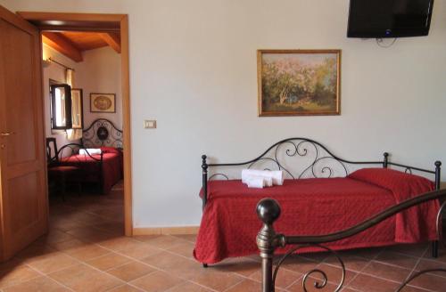 a bedroom with a red bed with a red blanket at Agriturismo Leone in Testa dellʼAcqua