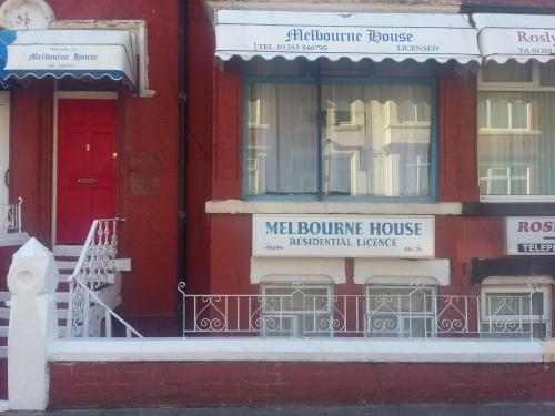 a red building with a red door and windows at The Midway in Blackpool