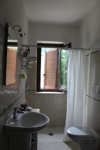 a bathroom with a sink and a shower with a window at Villa Sarno in Montesilvano