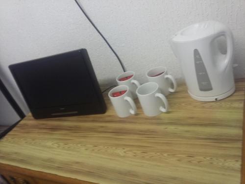 a table with four coffee cups and a monitor at The Midway in Blackpool