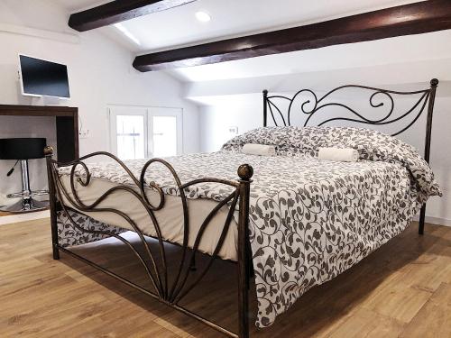 a bedroom with a black and white bed in a room at Altana Mario in Piran