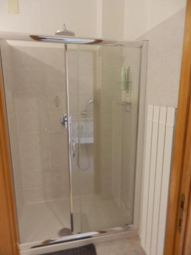 a glass shower with a sink on top of it at Appartamento Oscar in Tuoro sul Trasimeno