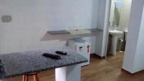 a kitchen with a counter with two remote controls on it at Villaggio D'Amore in Monte Verde