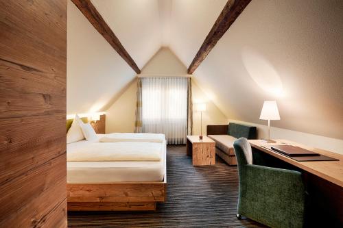 a hotel room with a bed and a desk at Hotel Kronelamm im Schwarzwald in Bad Teinach-Zavelstein