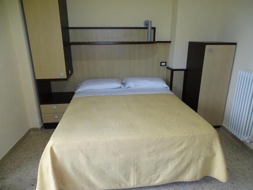 a bed with two pillows on it in a room at Monti Azzurri in Montemonaco