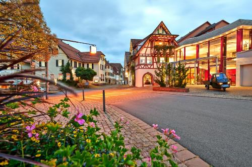 a street in a town with buildings and flowers at Hotel Kronelamm im Schwarzwald in Bad Teinach-Zavelstein