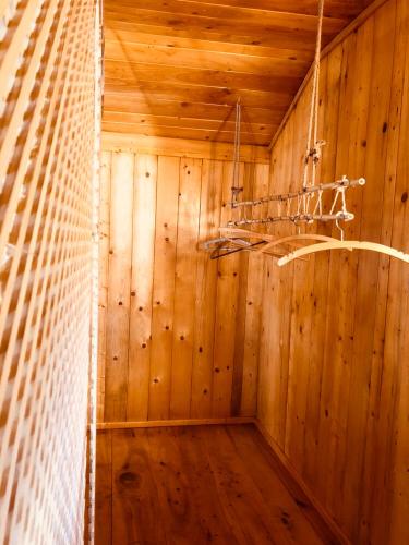 a room with wooden walls and a net at Dream Tricule in Sviniţa