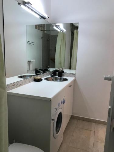 a bathroom with a washing machine and a sink at Aris sweet home in Athens