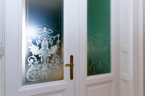 a white door with a sticker on it at Filip’s Palace Luxurious Apartment in Ljubljana