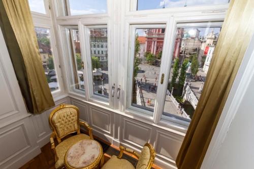 a room with two chairs and a window with a view at Filip’s Palace Luxurious Apartment in Ljubljana
