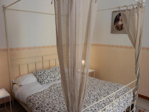 a bedroom with a bed with a canopy at Luciano And Son in Campobasso
