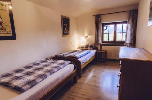 a room with two beds and a window at Haflingerhof - Oberjoch in Bad Hindelang
