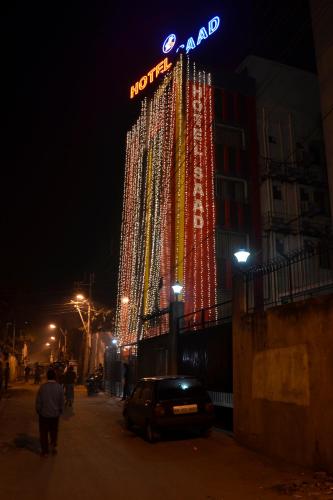 a building with a neon sign on it at night at Hotel Saad in Kolkata
