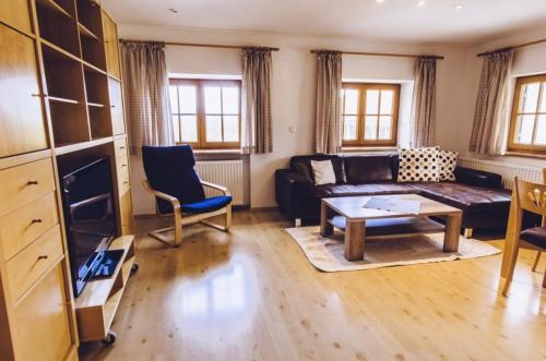 a living room with a couch and a table at Haflingerhof - Oberjoch in Bad Hindelang