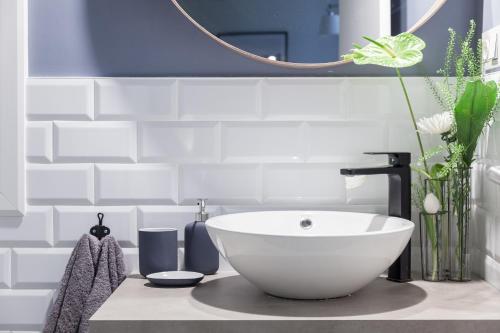 a bathroom with a white sink and a mirror at Chic Moraza by Chic Donosti in Donostia-San Sebastián
