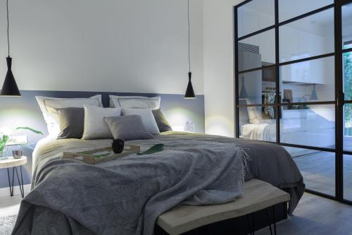 a bedroom with a large bed and a large window at Chic Moraza by Chic Donosti in Donostia-San Sebastián