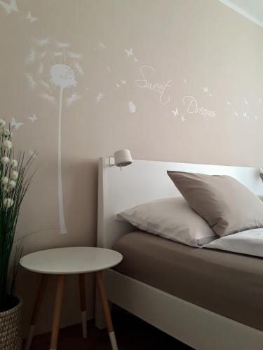 a bedroom with a bed with a dandelion wall sticker at Apartment Graz Murpromenade in Graz