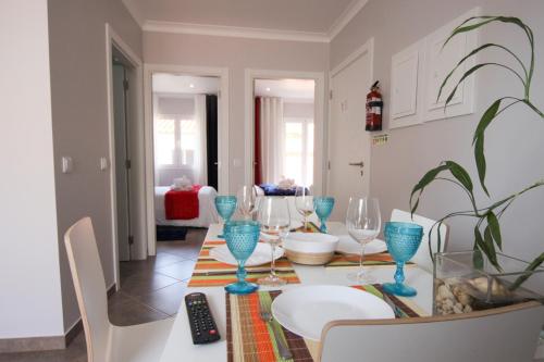 a dining room with a table with blue wine glasses at Ferhouse Dreams-Farilhões in Nazaré