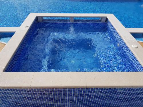 a large swimming pool with blue water in it at Apartmani Niksic in Herceg-Novi