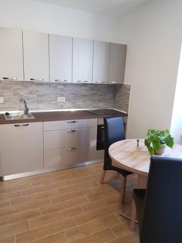 a kitchen with a table and a sink and a table and chairs at Port in Izola