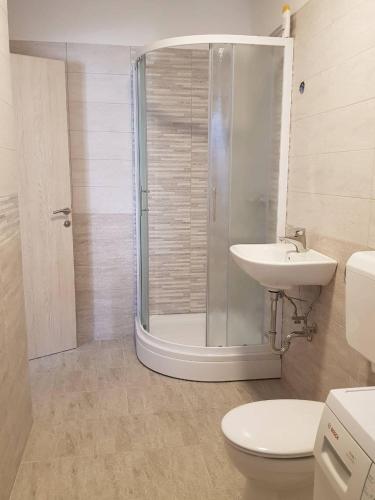a bathroom with a shower and a toilet and a sink at Port in Izola