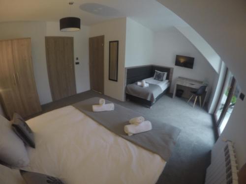 a bedroom with a bed and a living room at Silver Residence in Rabka