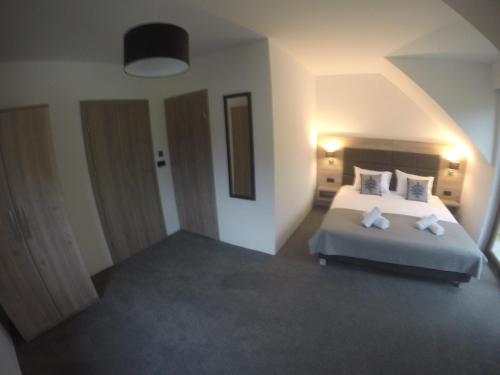 a bedroom with a bed with two pillows at Silver Residence in Rabka