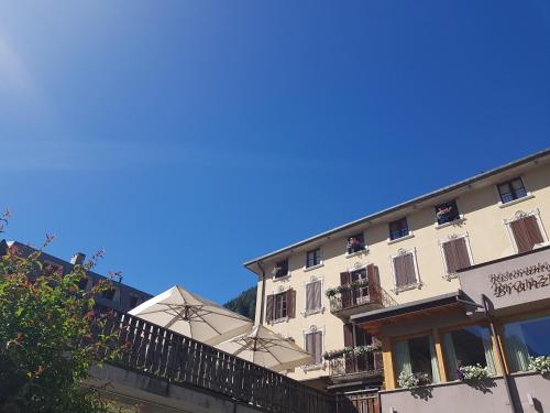 a building with a blue sky in the background at Hotel Pedretti in Branzi