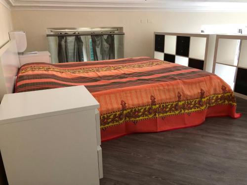 a bedroom with a bed with an orange blanket at ABCdecor Italia in Imperia