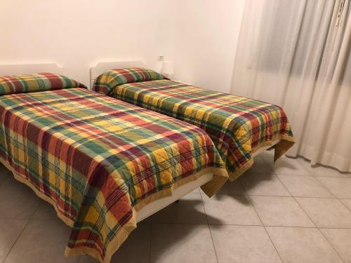 מיטה או מיטות בחדר ב-Residence Capo Nord