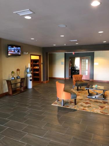 a lobby with furniture and a flat screen tv at Countryview Inn & Suites in Robinson