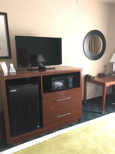 a large entertainment center with a flat screen tv at Countryview Inn & Suites in Robinson