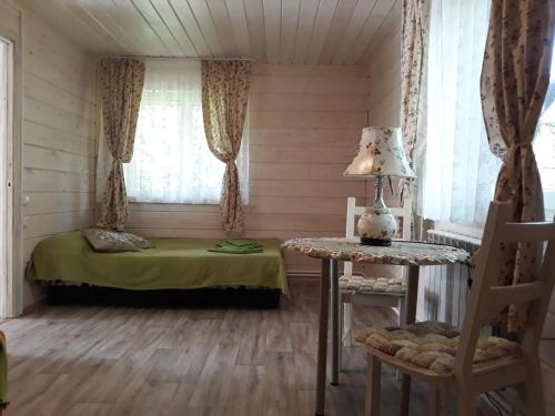 a bedroom with a bed and a table and a window at Vacation home in Konstantinovo in Konstantinovo