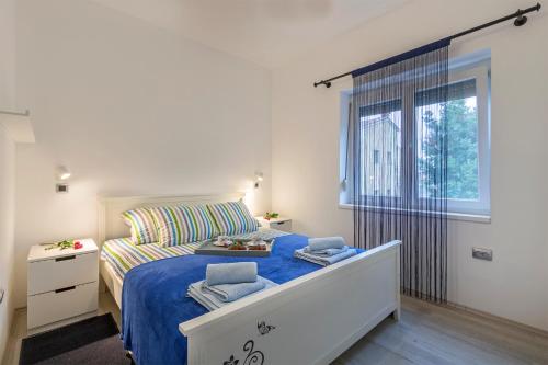 a bedroom with a bed and a large window at Apartment Danijela I in Pula