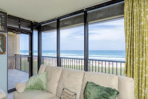 a living room with a couch and a view of the ocean at Sea Vista in South Padre Island