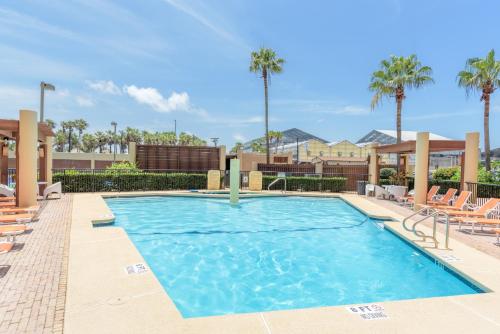 a swimming pool with lounge chairs and a resort at Sea Vista in South Padre Island