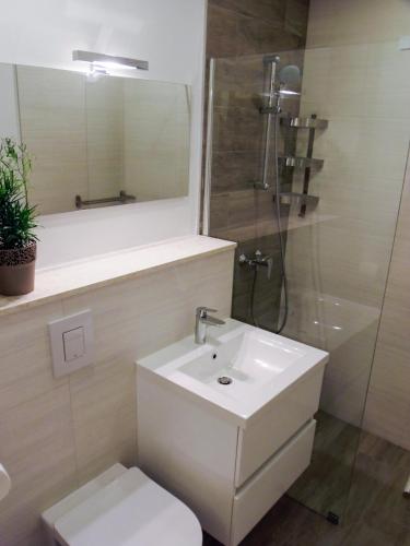 a bathroom with a sink and a toilet and a mirror at Villa Nobilo in Lumbarda