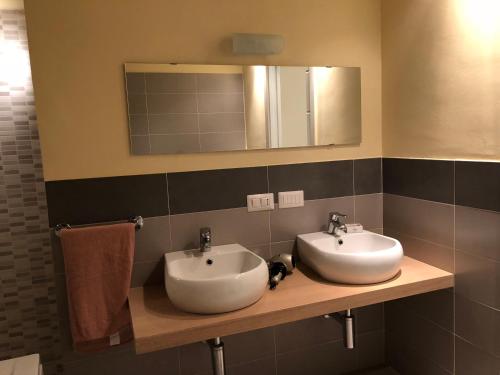 a bathroom with two sinks and a mirror at ABCdecor Italia in Imperia