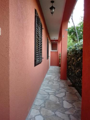 a hallway of a house with red walls at Bar-Apartman 2 in Bar