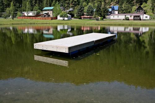 a dock in the middle of a body of water at Huckleberry Cabin in Dryden