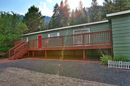 a house with a deck on the side of it at Huckleberry Cabin in Dryden