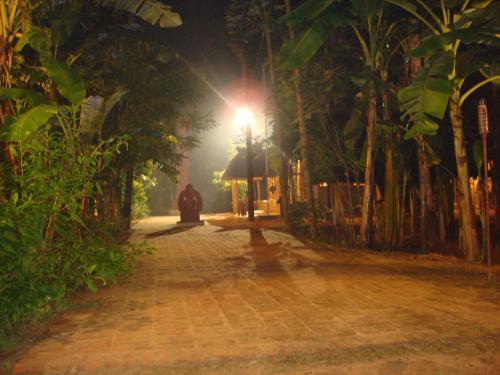 a cobblestone street at night with a street light at Indeco Hotels Swamimalai in Kumbakonam