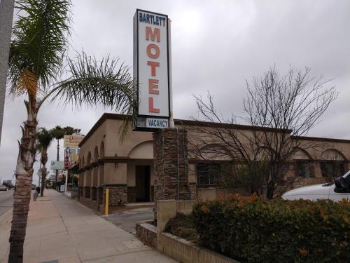 a building with a sign for a motel at Bartlett Motel in Lomita