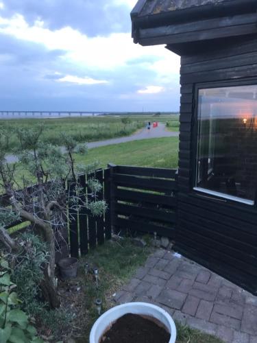 a house with a window and a fence and a yard at Beautiful location Copenhagen/Malmö in Malmö
