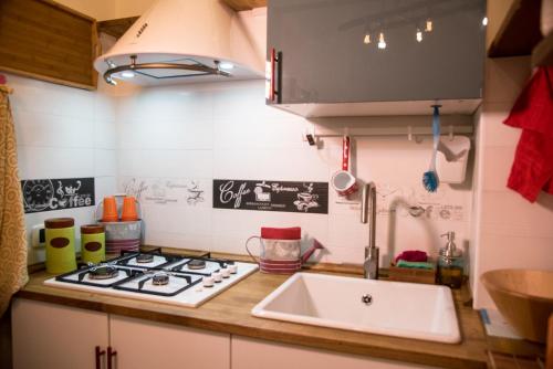 a kitchen with a sink and a stove at Guest Art Napoli in Naples
