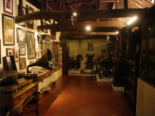 a room with a hallway with a room with paintings andartifacts at Indeco Hotels Swamimalai in Kumbakonam