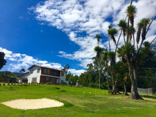 a house on a hill with palm trees at HOBU MONTAÑA in La Calera